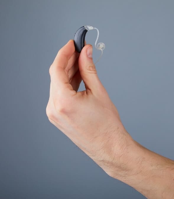 A Hand Holding Advanced Hearing Aid Device